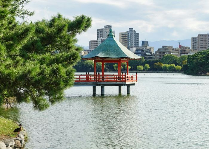 A bright red pagoda in a lake at Ohori Park,